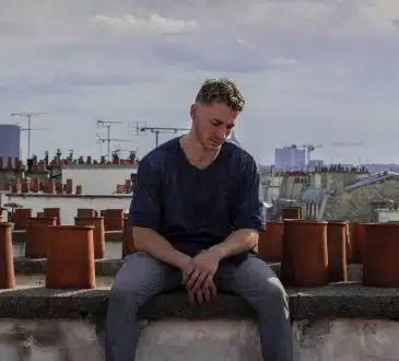 man sitting on roof deck